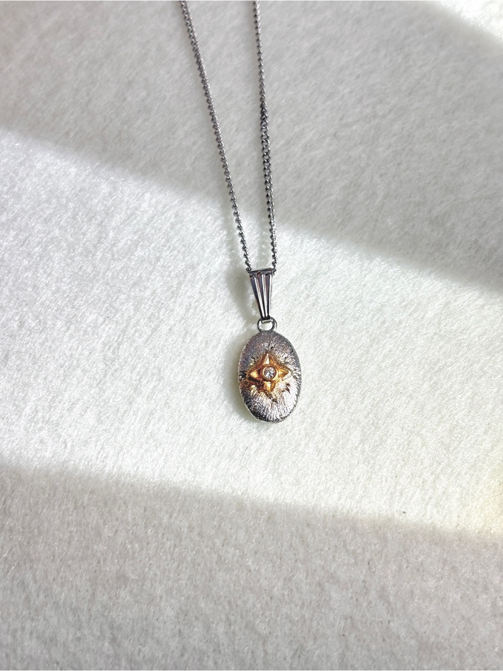 Silver Oval Starburst Pendant Necklace with Gold Accent
